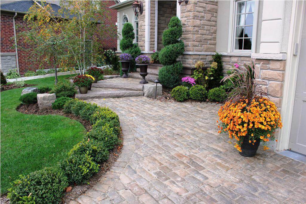 Classic Entryway with Structured Evergreen Beds